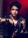 Teen guy posing with guitar