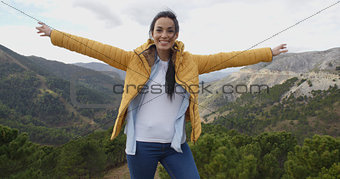Fun young woman on a mountain