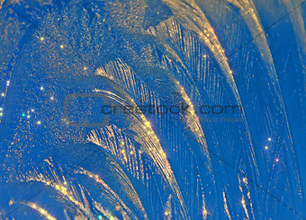 Sparkling ice-rich frosty pattern of thin ice on the window.