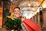Woman with Christmas tree and shopping bags in Venice