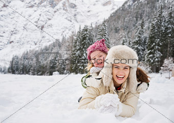 Portrait of smiling mother and child playing outdoors
