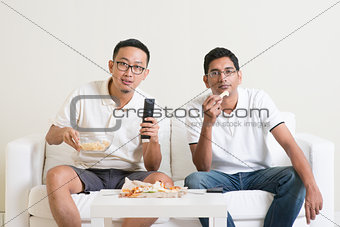 Men watching sport game on tv together