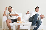 Men watching live sport match on tv at home