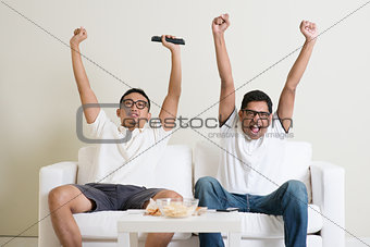 Men watching football match on tv together