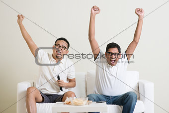 Men watching football game together
