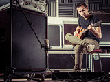Man recording guitar tracks in a studio