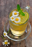 cup of chamomile tea with  flowers