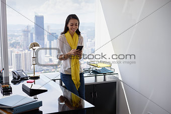 Young Latina Business Woman With Phone In Office 