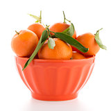 Tangerines on ceramic orange bowl 