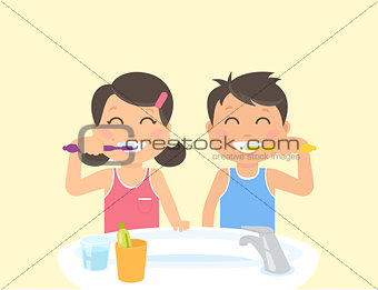 Happy kids brushing teeth standing in the bathroom near sink