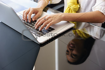 Business Woman Smiling And Typing On Office Laptop Computer