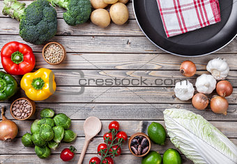 Various vegetables fruits and herbs with a frying pan