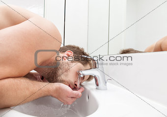 Man drinks tap water 