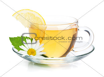 Cup of tea with lemon slice, mint leaves and chamomile flower