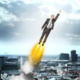 Businessman in suit flying
