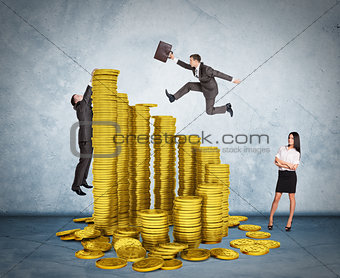 Businessman running on stack of coins