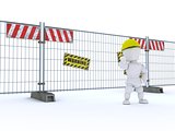 man with construction barrier fence
