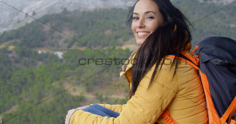 Happy vivacious young woman backpacker