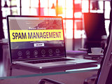 Spam Management on Laptop in Modern Workplace Background.