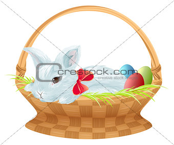 Easter bunny in wicker basket. Cute easter bunny sitting in basket with color eggs