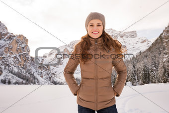 Portrait of happy woman outdoors among snow-capped mountains