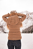 Seen from behind woman outdoors looking on snow-capped mountains