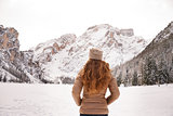 Seen from behind woman outdoors among snow-capped mountains
