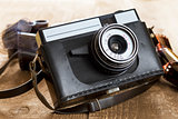 Vintage photo camera and blank film strip 