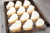 Cut french loaf bread on baking tray