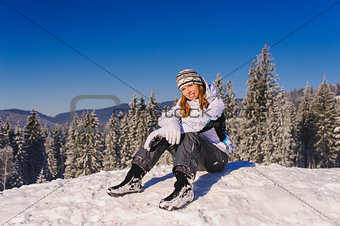 Girl sitting on ski slope