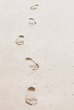 Human footprints leading towards the viewer. Copyspace on right