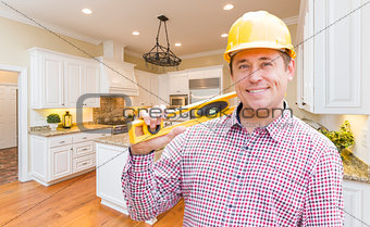 Contractor with Level Wearing Hard Hat Standing In Custom Kitchen