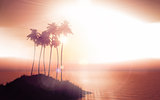 Palm tree island against a sunset sky