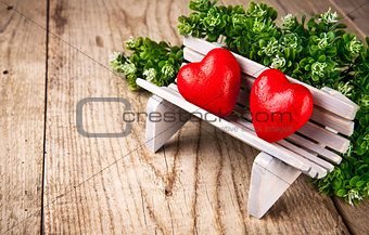 Couple in love of two heart on bench