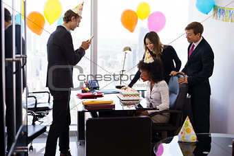 Business People Celebrating Colleague Birthday Party In Office