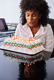 Business Woman Celebrating Birthday Party In Office Blowing Cand