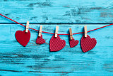 red hearts hanging in a clothes line