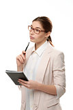 Young stylish woman standing holding a notepad and a pen.