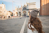 Seen from behind young woman standing on Piazza San Marco