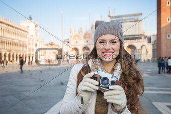 Young woman with retro photo camera on Piazza San Marco