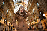 Smiling young woman standing in Galleria Vittorio Emanuele II