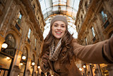 Woman shopper taking selfie in Galleria Vittorio Emanuele II