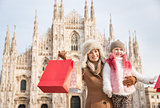 Portrait of mother and daughter with shopping bags near Duomo