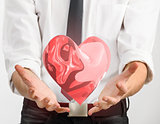 Red glass heart in businessman hands