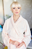 Blond beautiful woman in pink dressing gown