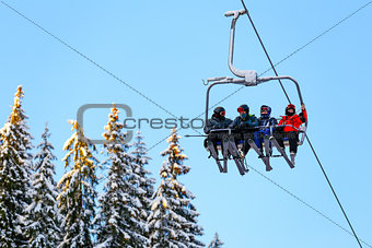 Bottom view ski family on chair lift