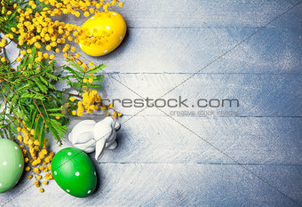 Easter still life with branch mimosa eggs