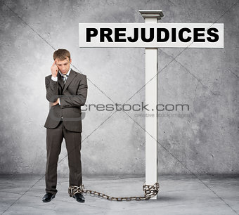 Businessman word prejudice on post sign