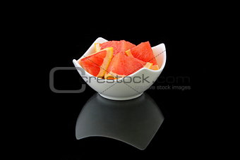 grapefruit pieces in a porcelain bowl