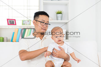 Father burping baby after meal